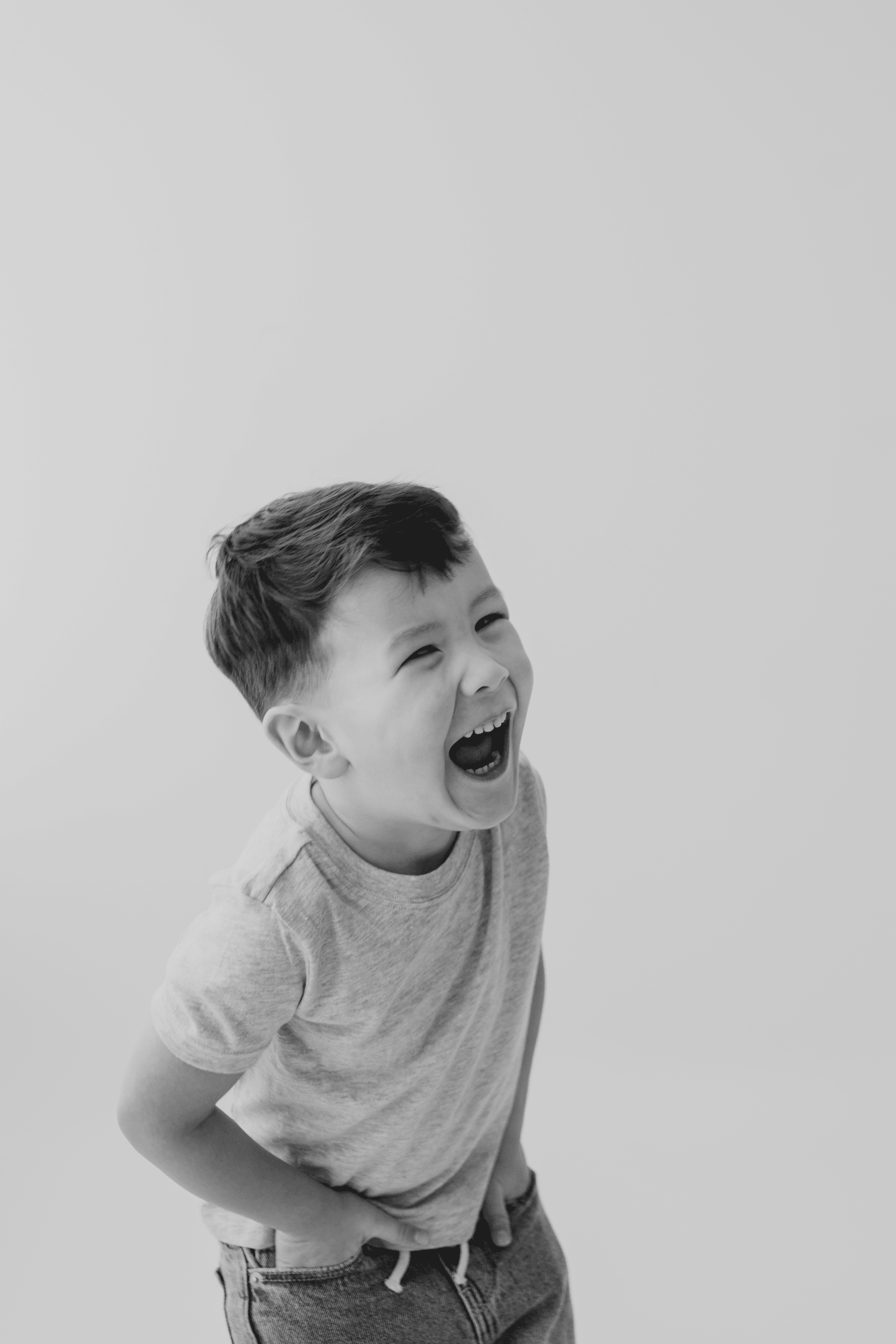 Happy boy laughing during a professional photoshoot for seasonal mini sessions in Prince George, BC.